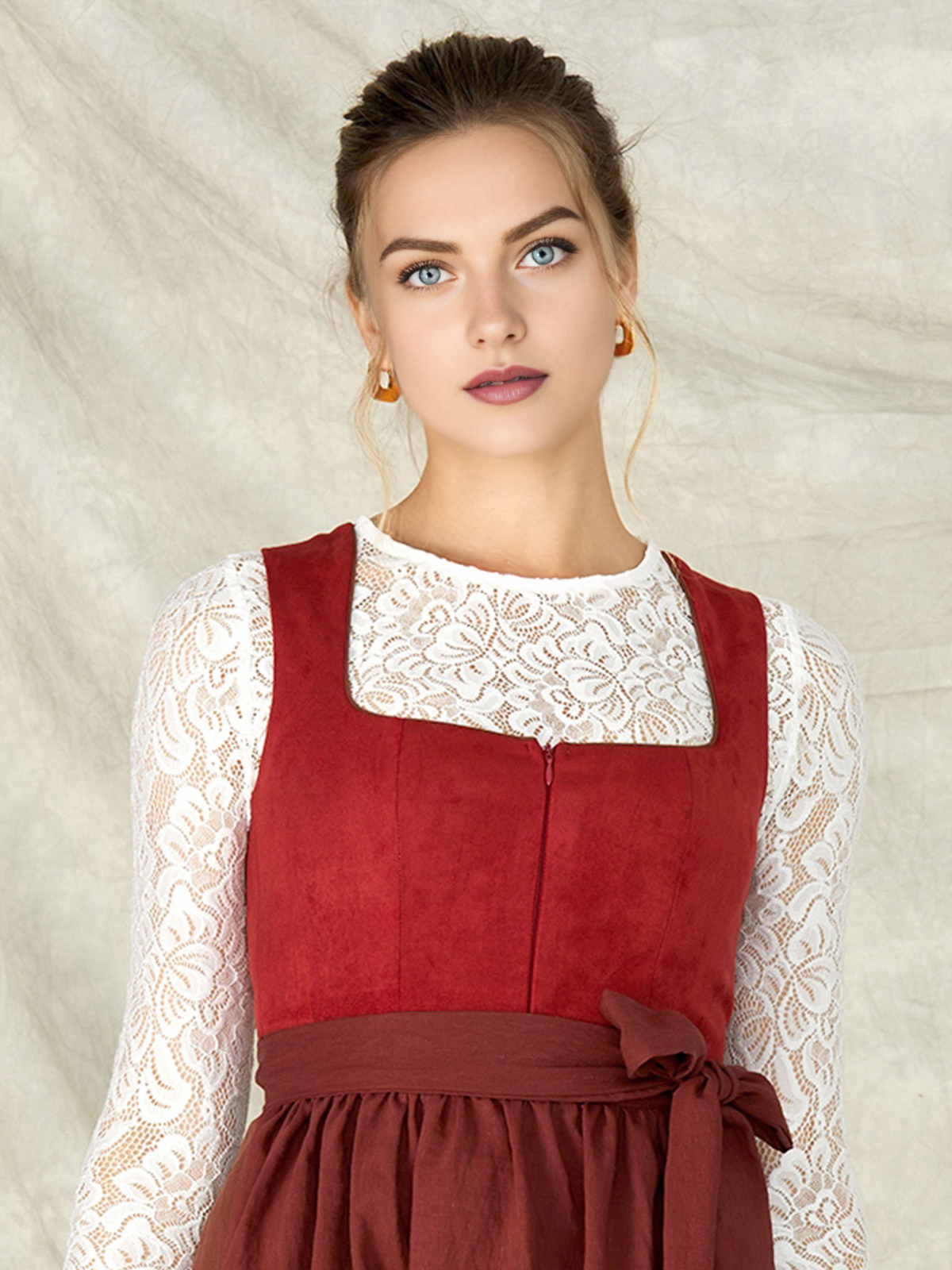 Ein modernes helles Dirndl in Rot mit aufwendigen Details